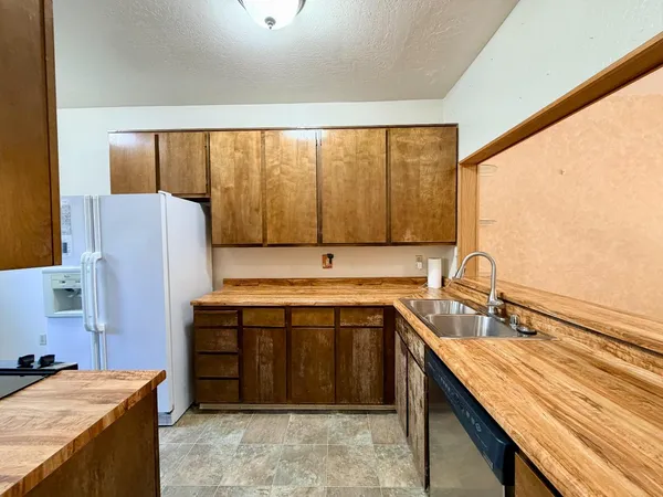 a kitchen with a sink and a refrigerator