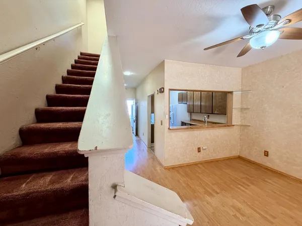 a view of a living room with furniture and wooden floor
