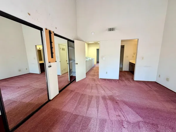 a view of hallway with wooden floor and stairs