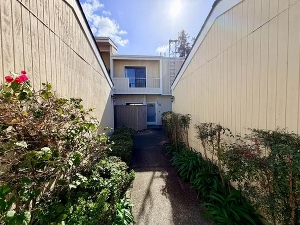 a view of a house with a flower garden