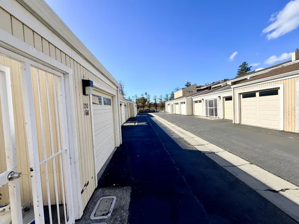 a sign that is sitting in front of flowers