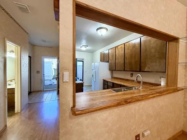 a view of a kitchen with a sink and a wooden floor