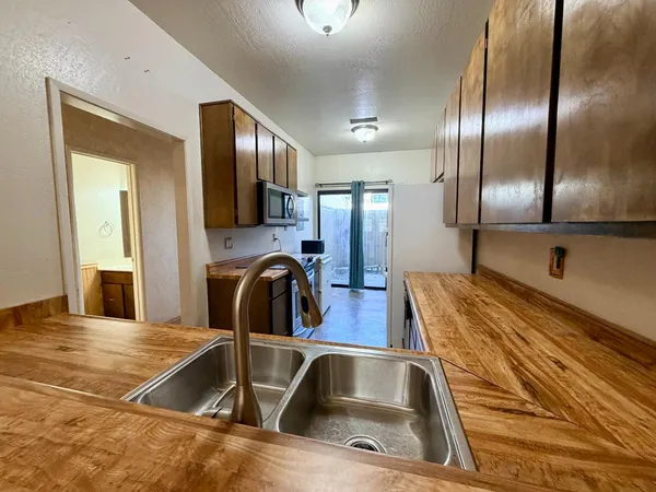 a kitchen with a sink and a refrigerator