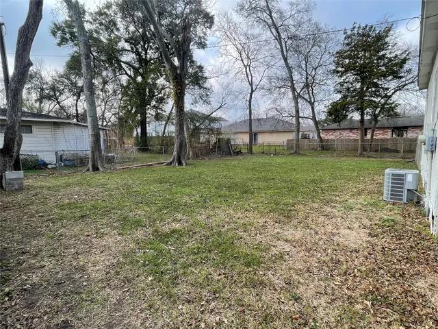 a view of a backyard with large trees