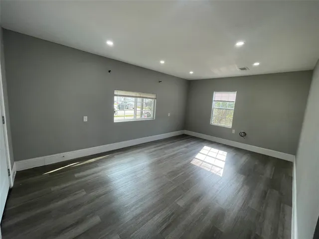 a view of an empty room and a window