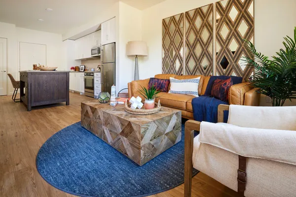 a living room with furniture and wooden floor