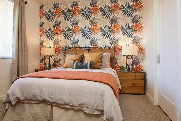 a bedroom with a bed and a painting on the wall