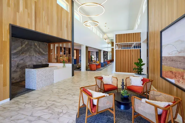 a living room with patio furniture and a large window