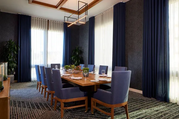 a dining room with furniture window and wooden floor