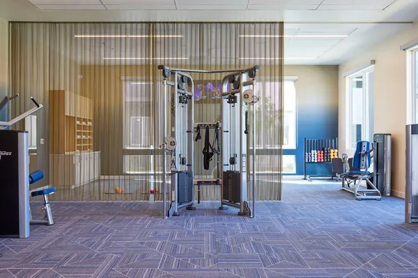 a view of hallway with glass door and couch