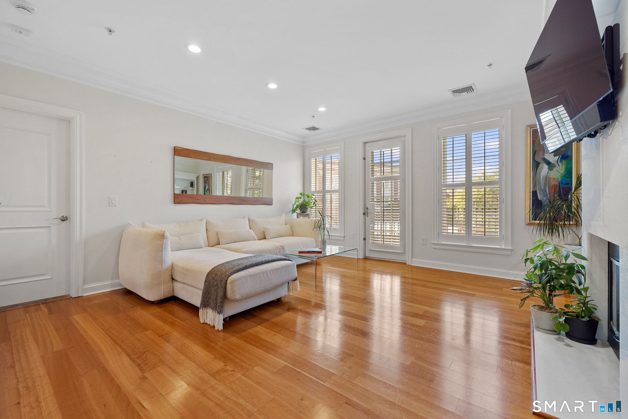 85 Memorial Road, Unit 205 West Hartford, CT 06107 - Photo 11 of 40 a spacious bedroom with a large bed and a chandelier
