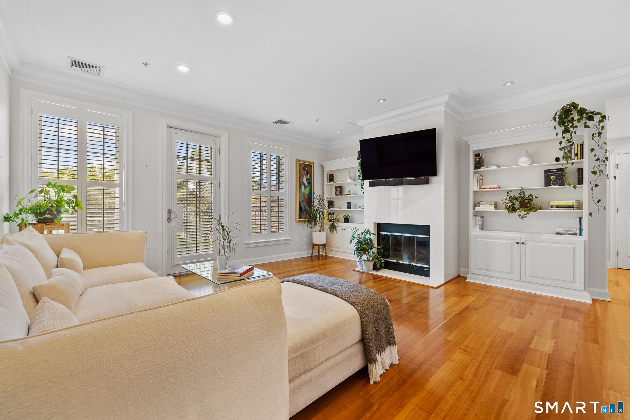 85 Memorial Road, Unit 205 West Hartford, CT 06107 - Photo 13 of 40 a bedroom with a bed and a flat screen tv