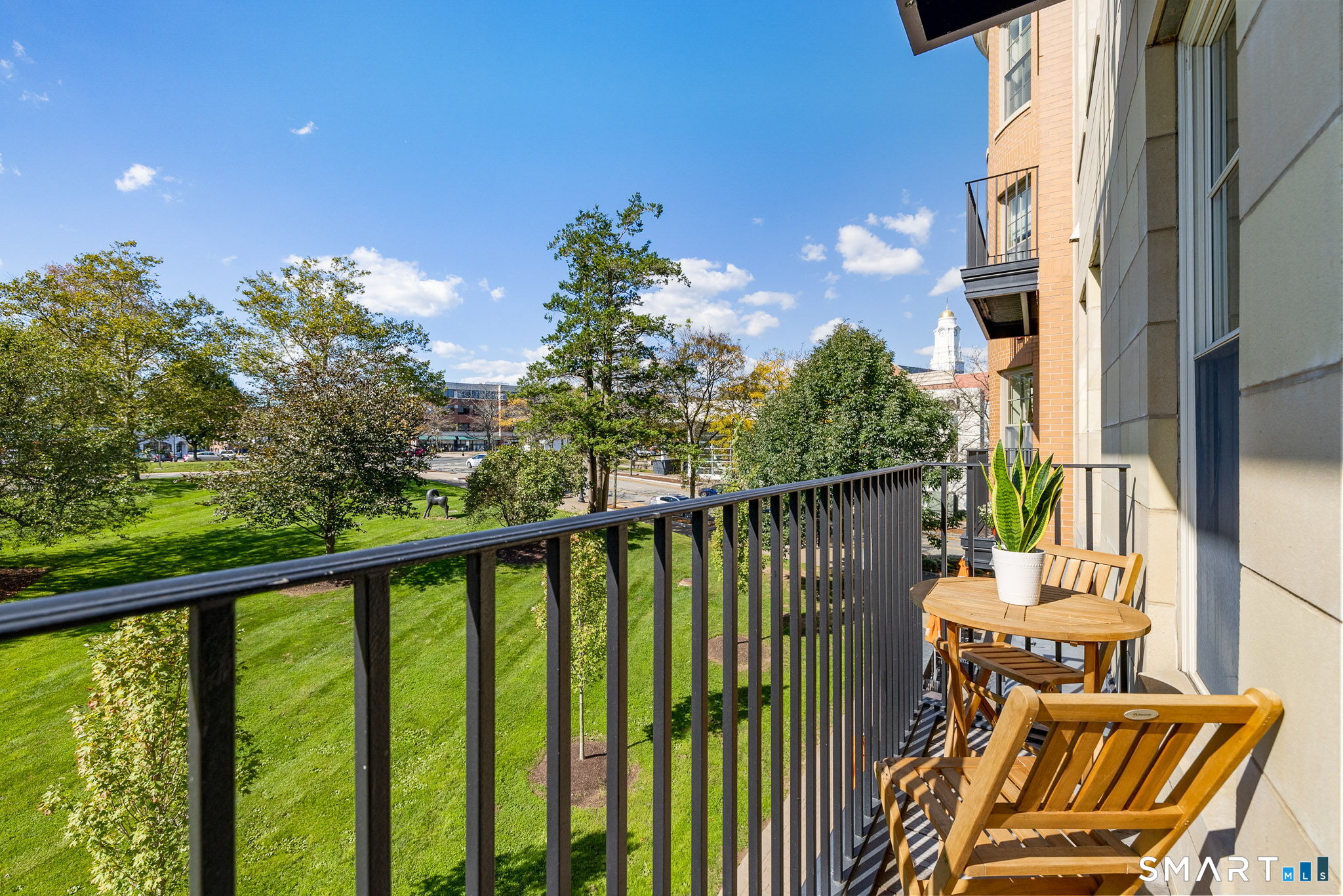 85 Memorial Road, Unit 205 West Hartford, CT 06107 - Photo 15 of 40 a view of a balcony with wooden floor and outdoor space