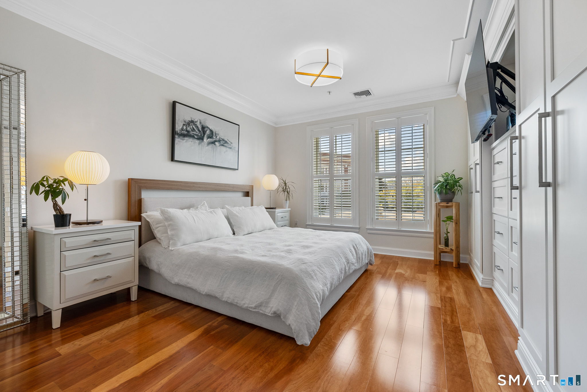 85 Memorial Road, Unit 205 West Hartford, CT 06107 - Photo 16 of 40 a spacious bedroom with a bed and a window