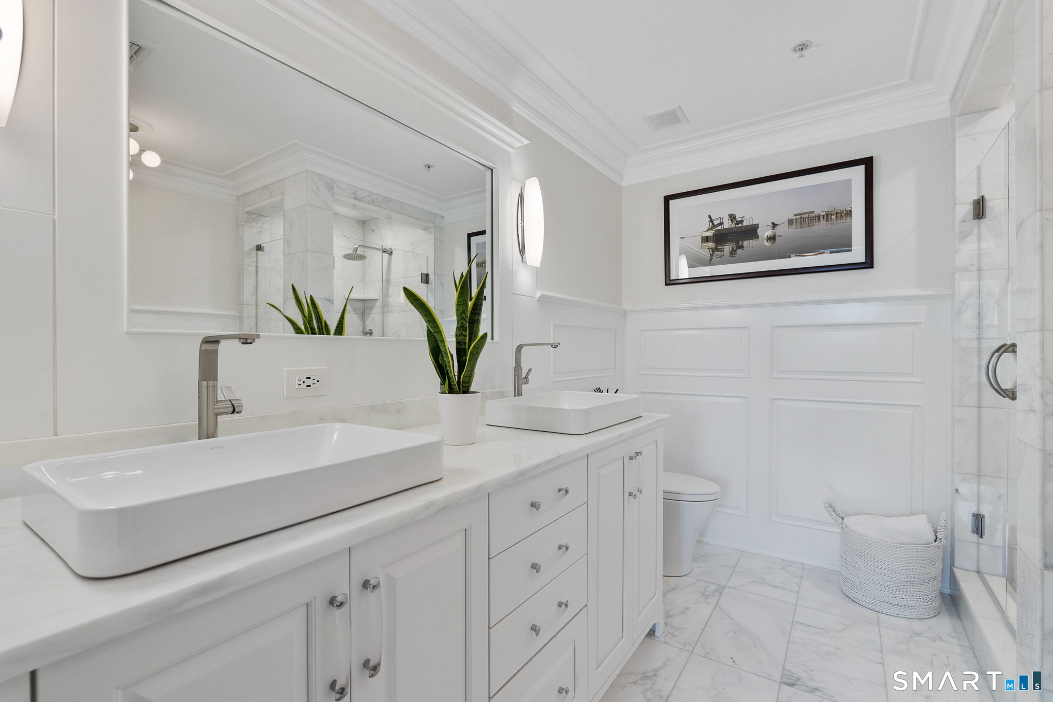 85 Memorial Road, Unit 205 West Hartford, CT 06107 - Photo 19 of 40 a bathroom with a double vanity sink toilet and a mirror