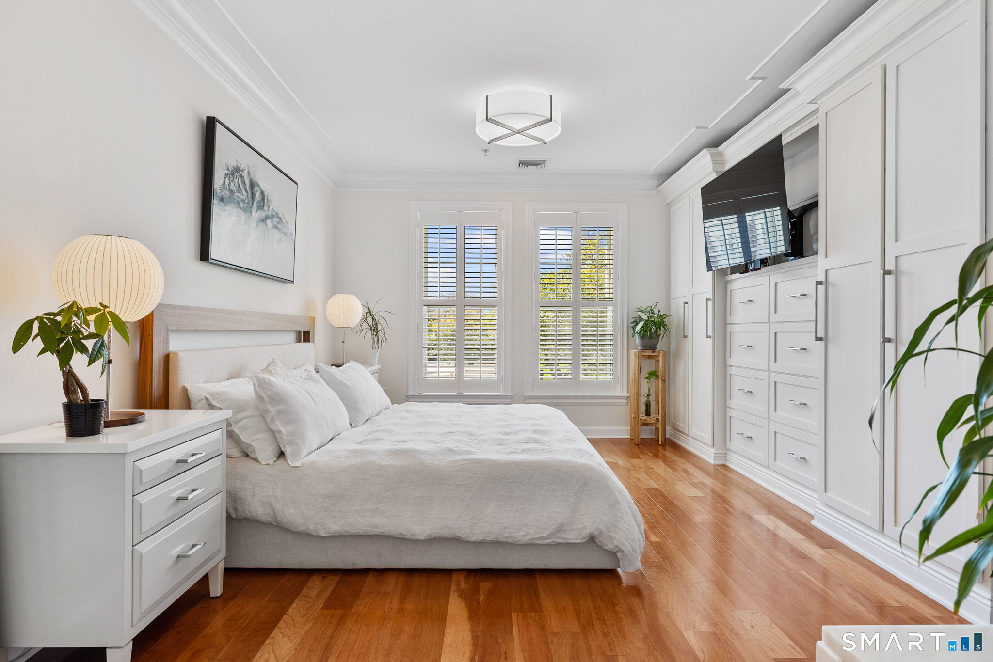 85 Memorial Road, Unit 205 West Hartford, CT 06107 - Photo 24 of 40 a bedroom with a bed and a flat screen tv