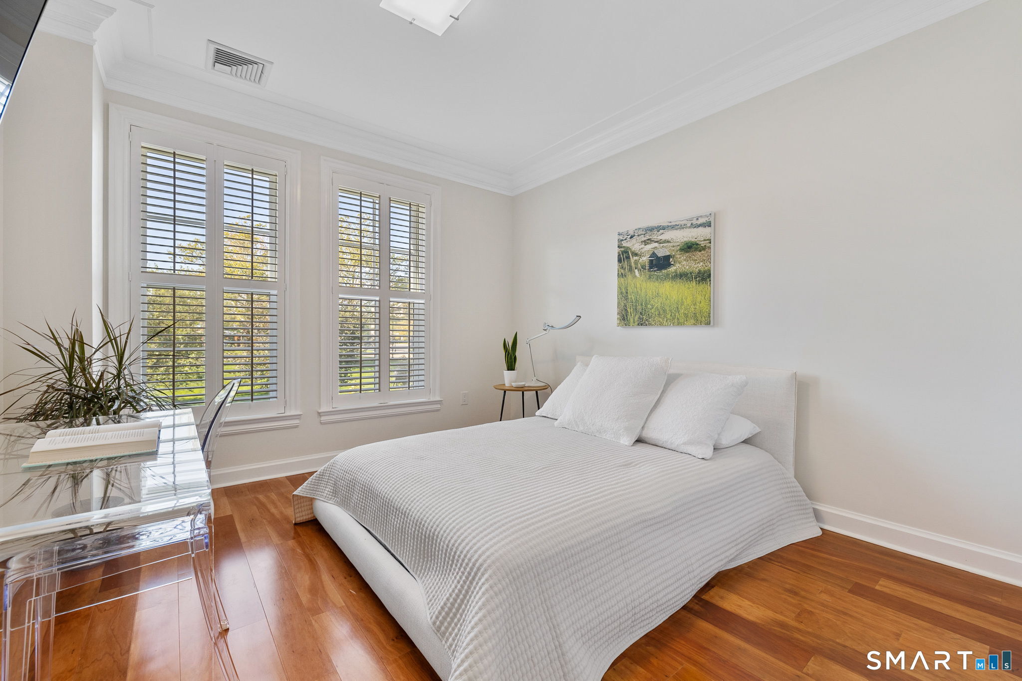85 Memorial Road, Unit 205 West Hartford, CT 06107 - Photo 26 of 40 a bed sitting in a bedroom next to a window