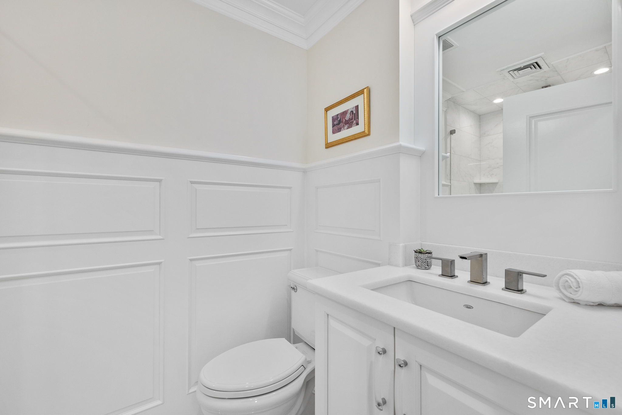 85 Memorial Road, Unit 205 West Hartford, CT 06107 - Photo 27 of 40 a bathroom with a sink a toilet and a mirror