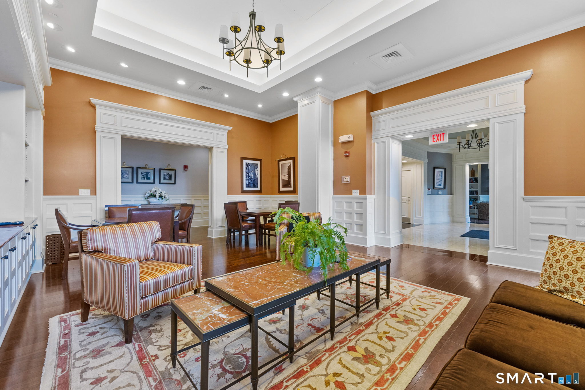 85 Memorial Road, Unit 205 West Hartford, CT 06107 - Photo 30 of 40 a living room with furniture and a chandelier