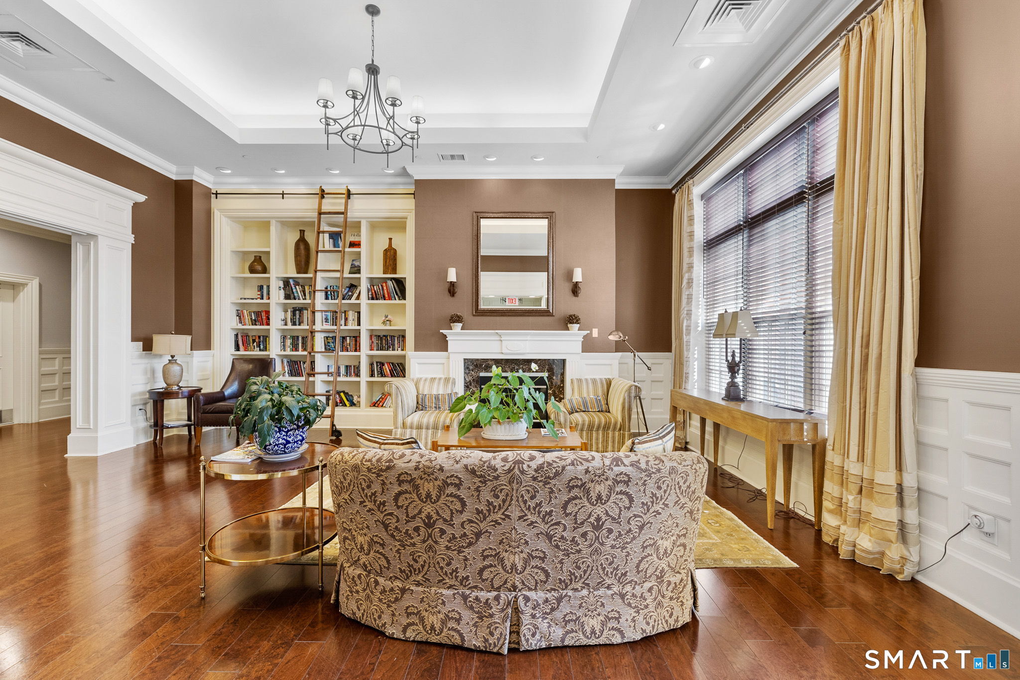 85 Memorial Road, Unit 205 West Hartford, CT 06107 - Photo 31 of 40 a living room with fireplace furniture and a chandelier
