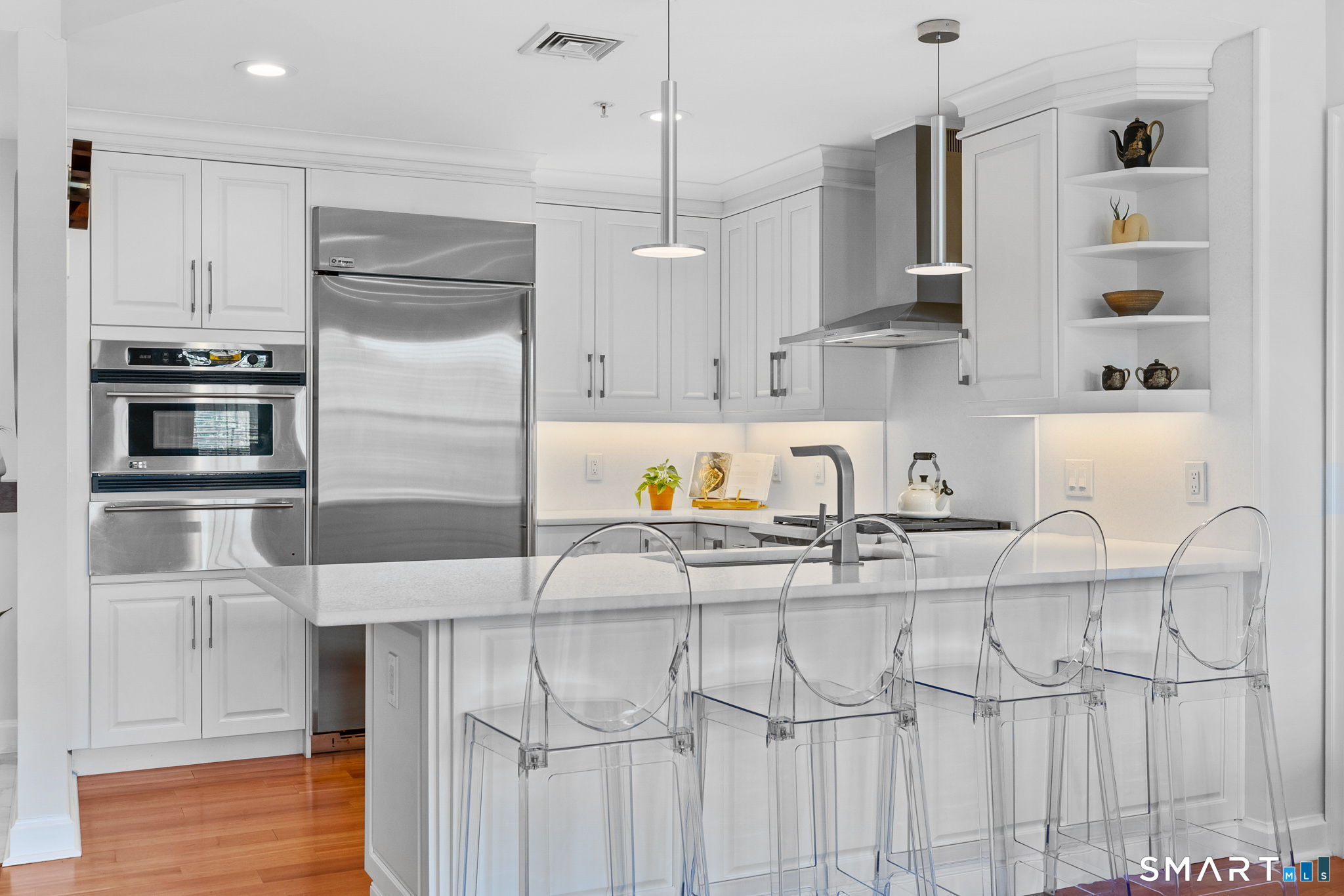 85 Memorial Road, Unit 205 West Hartford, CT 06107 - Photo 4 of 40 a kitchen with kitchen island granite countertop a sink cabinets and stainless steel appliances