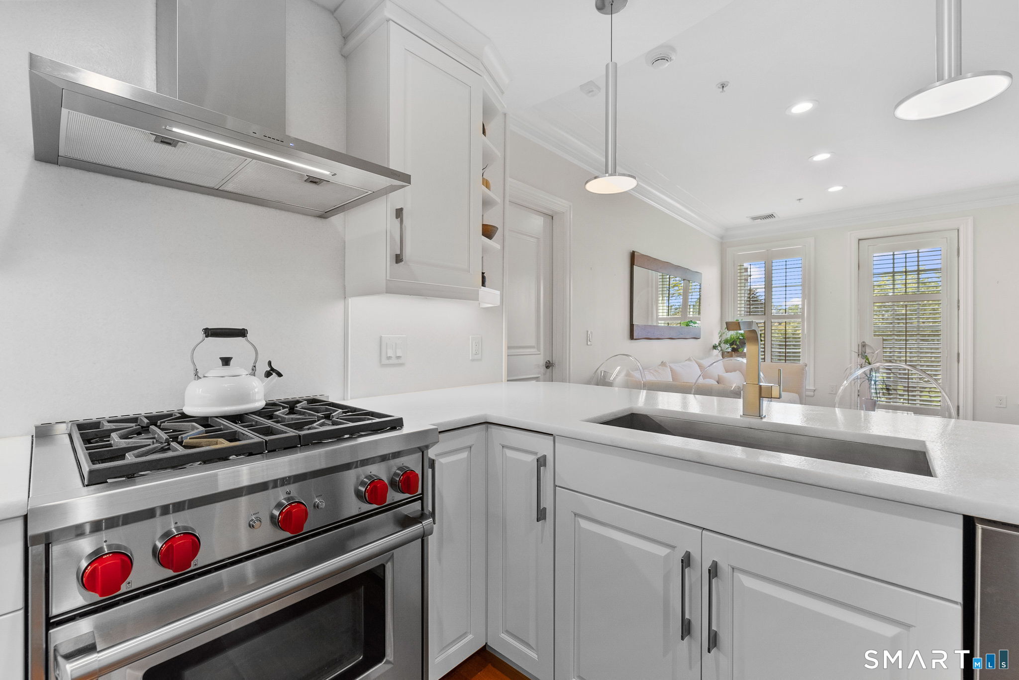 85 Memorial Road, Unit 205 West Hartford, CT 06107 - Photo 6 of 40 a kitchen with stainless steel appliances a sink stove and cabinets