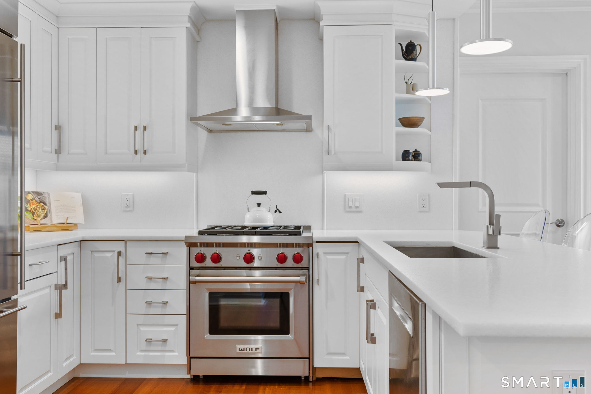 85 Memorial Road, Unit 205 West Hartford, CT 06107 - Photo 8 of 40 a kitchen with cabinets a stove and a sink