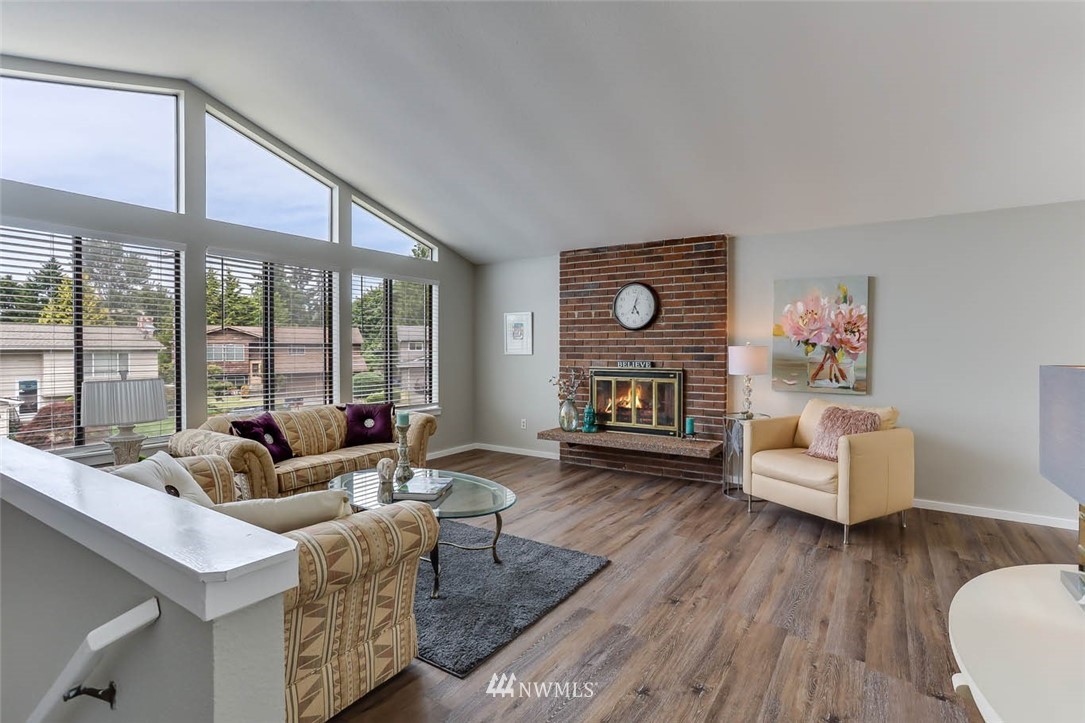 2805 Northeast 23rd Place Renton, WA 98056 - Photo 4 of 27 a living room with fireplace furniture and a wooden floor