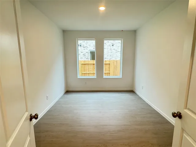 a dining room with furniture and a potted plant