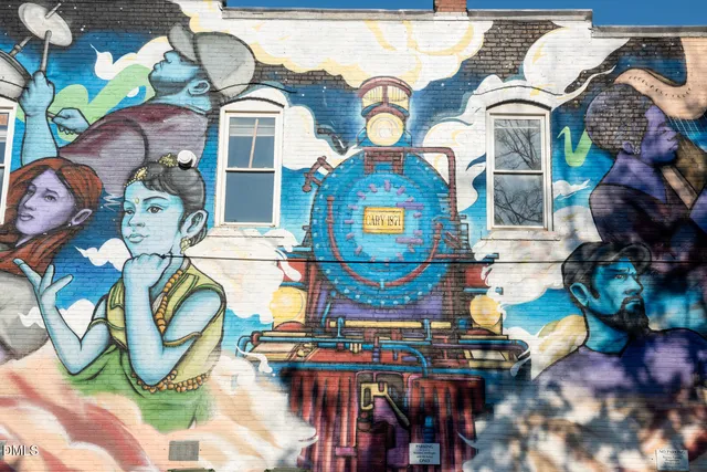 an aerial view of residential houses with outdoor space and parking