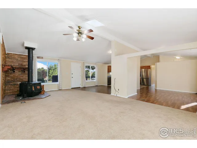 a view of a livingroom with furniture a flat screen tv and a fireplace