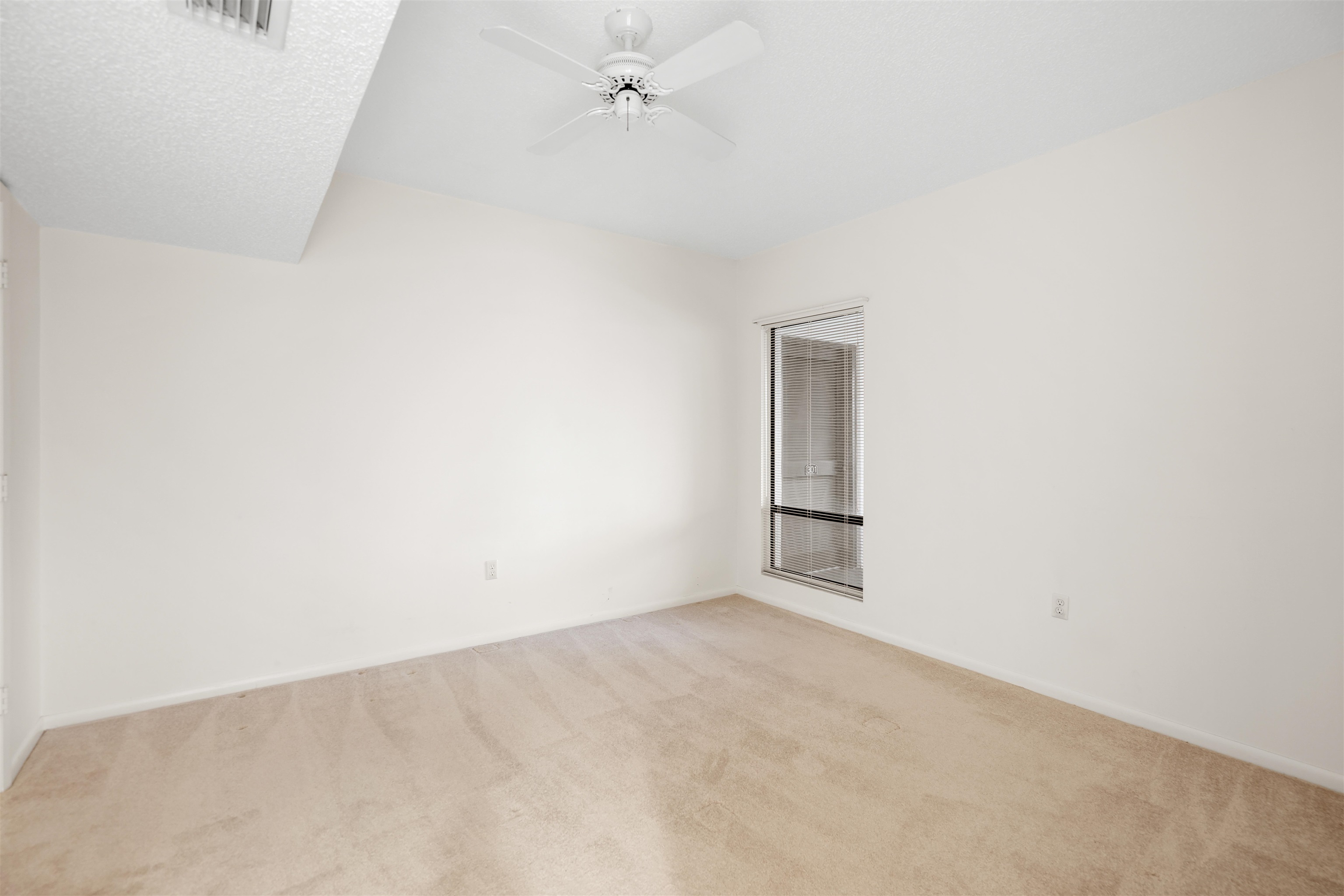 20 Dondanville Road, Unit A302 St. Augustine, FL 32080 - Photo 24 of 43 an empty room with a fan and a window
