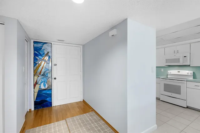 a view of a kitchen with fridge and sink