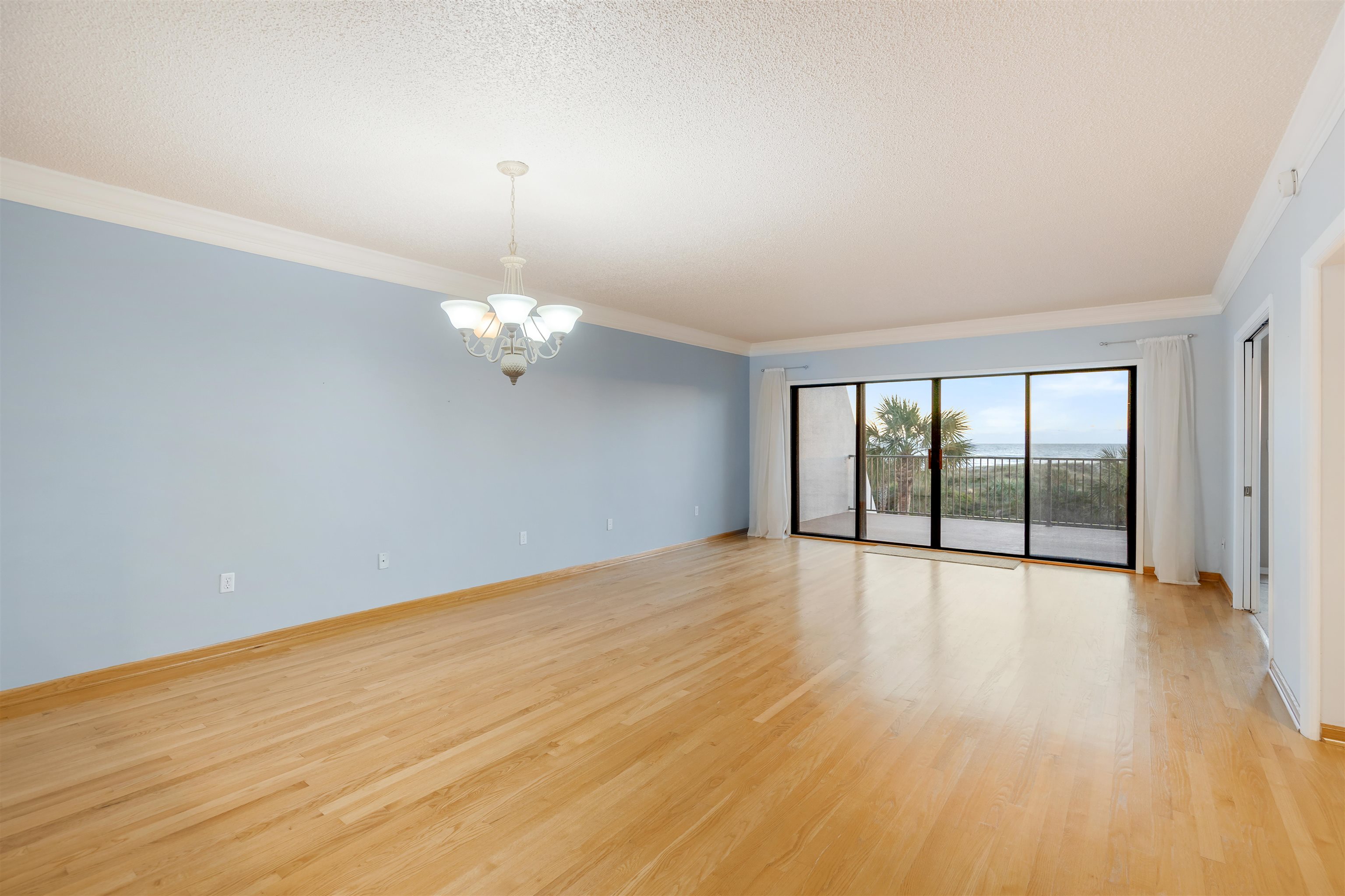 20 Dondanville Road, Unit A302 St. Augustine, FL 32080 - Photo 10 of 43 a view of an empty room with wooden floor and a window