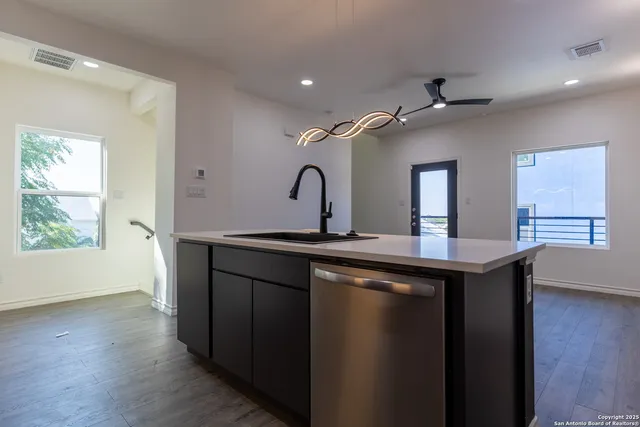 a kitchen with stainless steel appliances granite countertop a stove a microwave and a sink