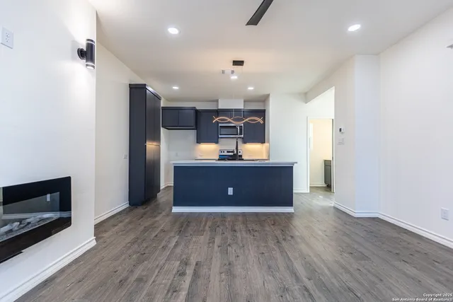 a view of kitchen with furniture and wooden floor