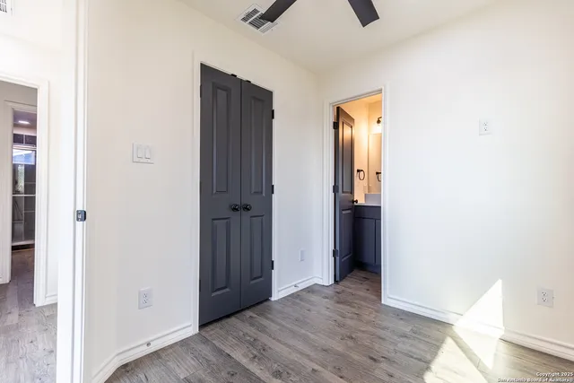 a view of a hallway with wooden floor and entryway