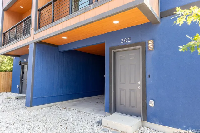 a view of staircase with wooden floor and white walls