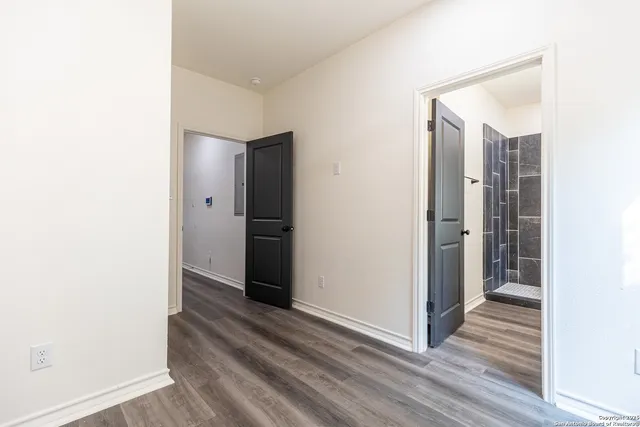 a view of a hallway with wooden floor
