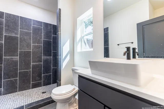 a kitchen with a refrigerator sink and cabinets