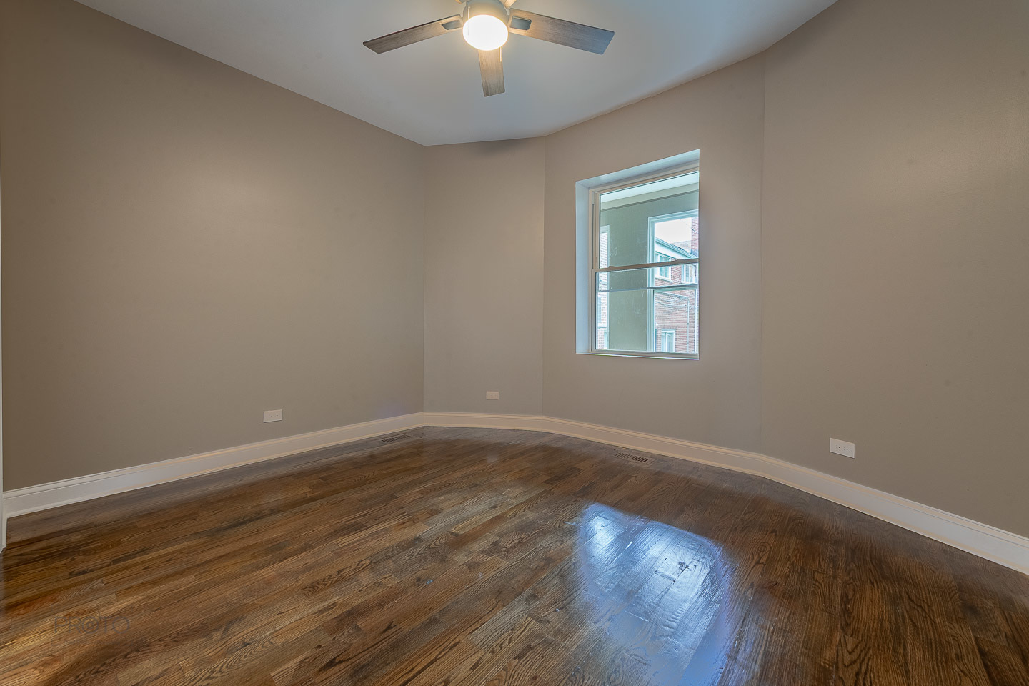 35 North Mayfield Avenue, Unit 2 Chicago, IL 60644 - Photo 12 of 15 a view of an empty room with wooden floor and a window