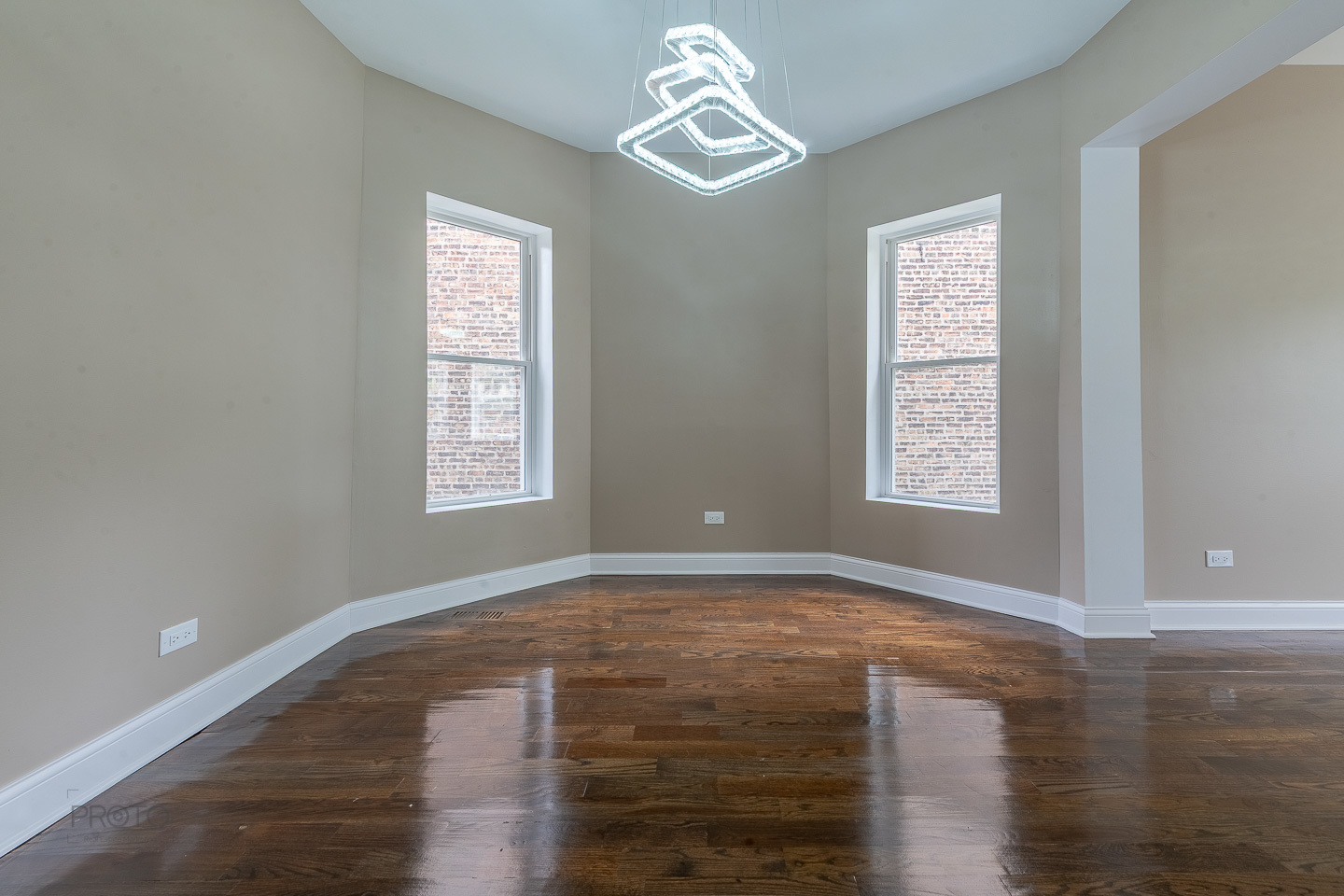 35 North Mayfield Avenue, Unit 2 Chicago, IL 60644 - Photo 4 of 15 a view of empty room with wooden floor and fan