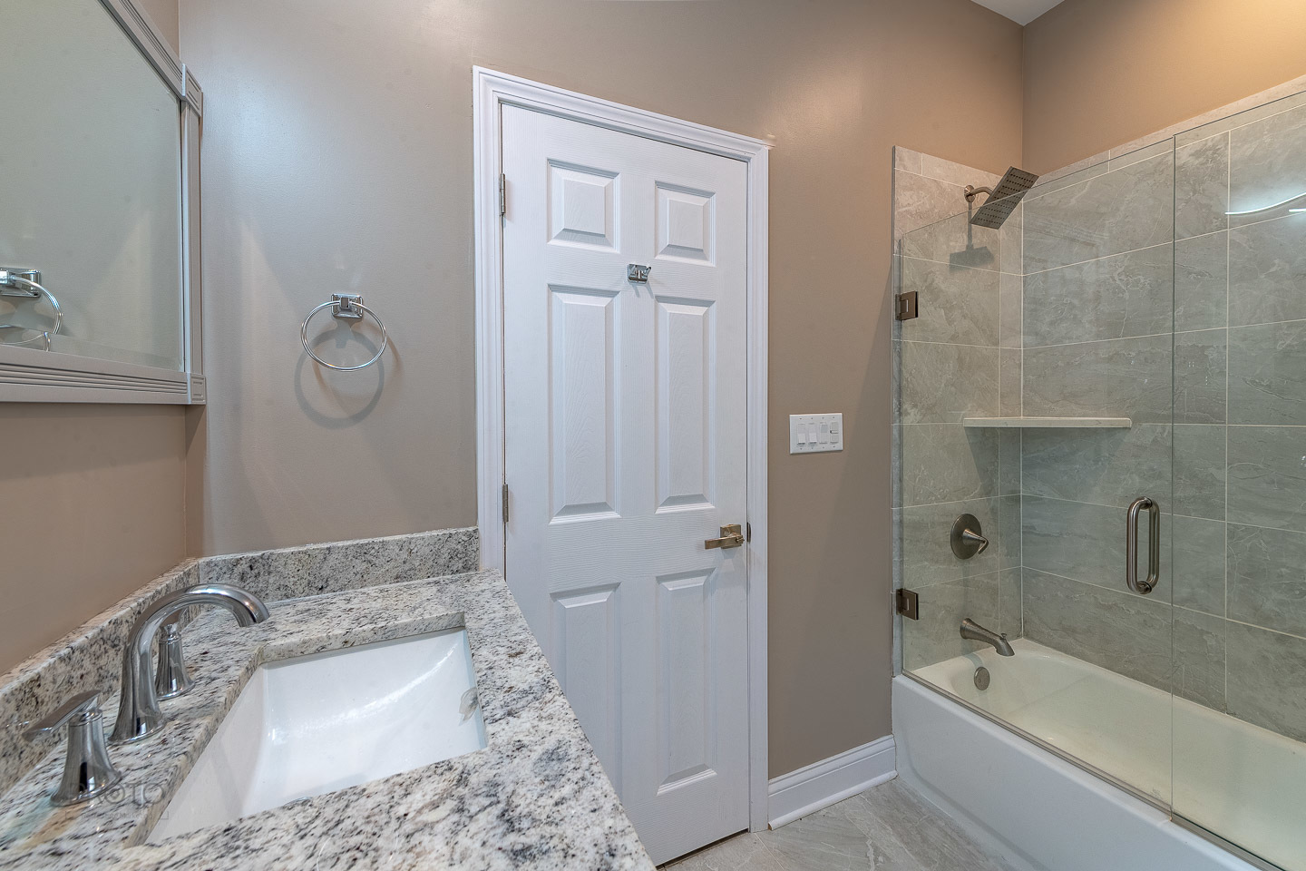 35 North Mayfield Avenue, Unit 2 Chicago, IL 60644 - Photo 5 of 15 a bathroom with a granite countertop sink a toilet and bathtub