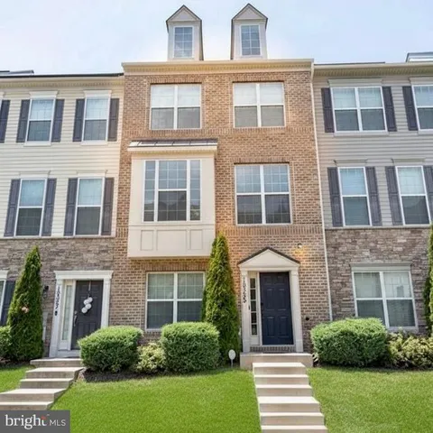 a front view of a house with garden and entryway