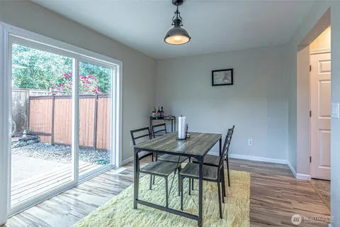 a view of a dining room with furniture wooden floor and a carpet