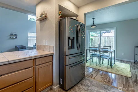 a kitchen with stainless steel appliances granite countertop a refrigerator and a sink