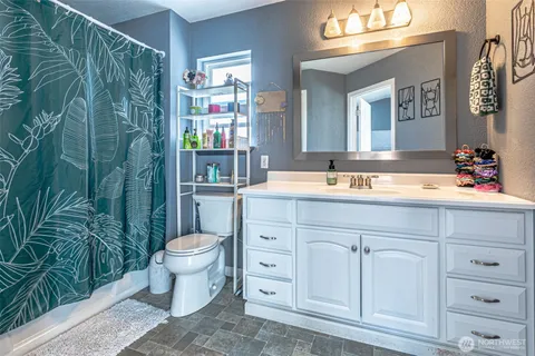 a bathroom with a sink a toilet and a mirror