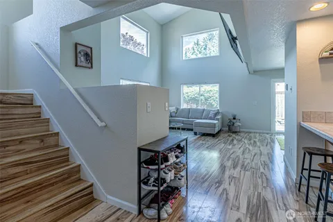 a view of entryway and hall with wooden floor