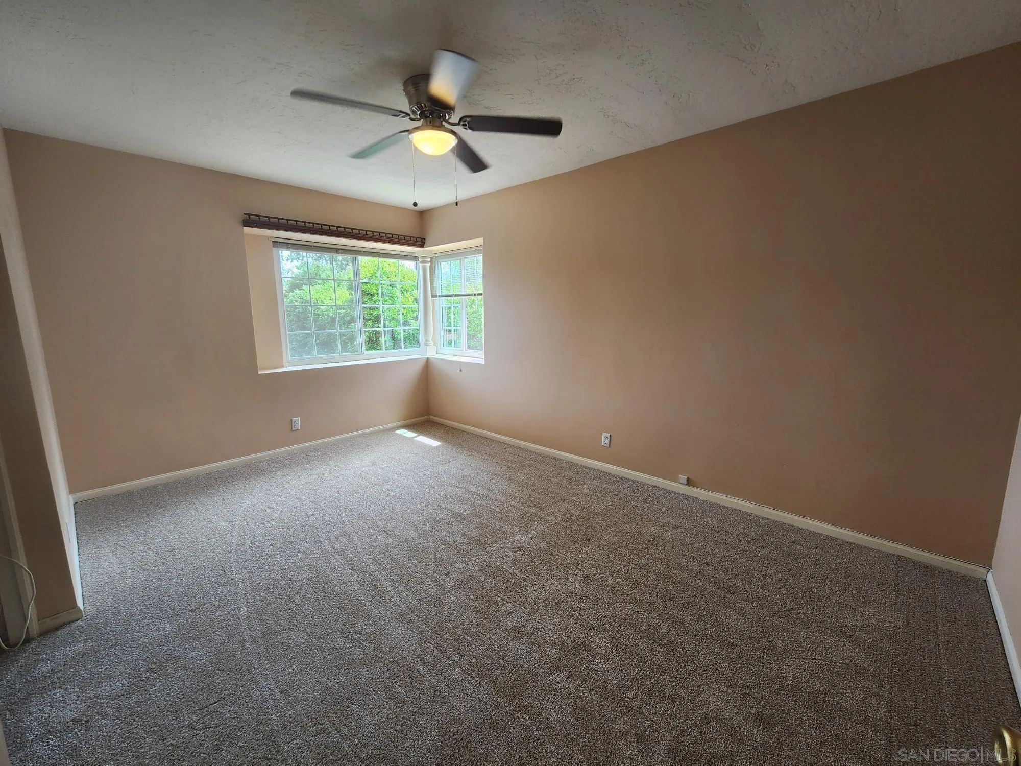 1972 Buena Creek Road Vista, CA 92084 - Photo 11 of 22 an empty room with a window and a fan