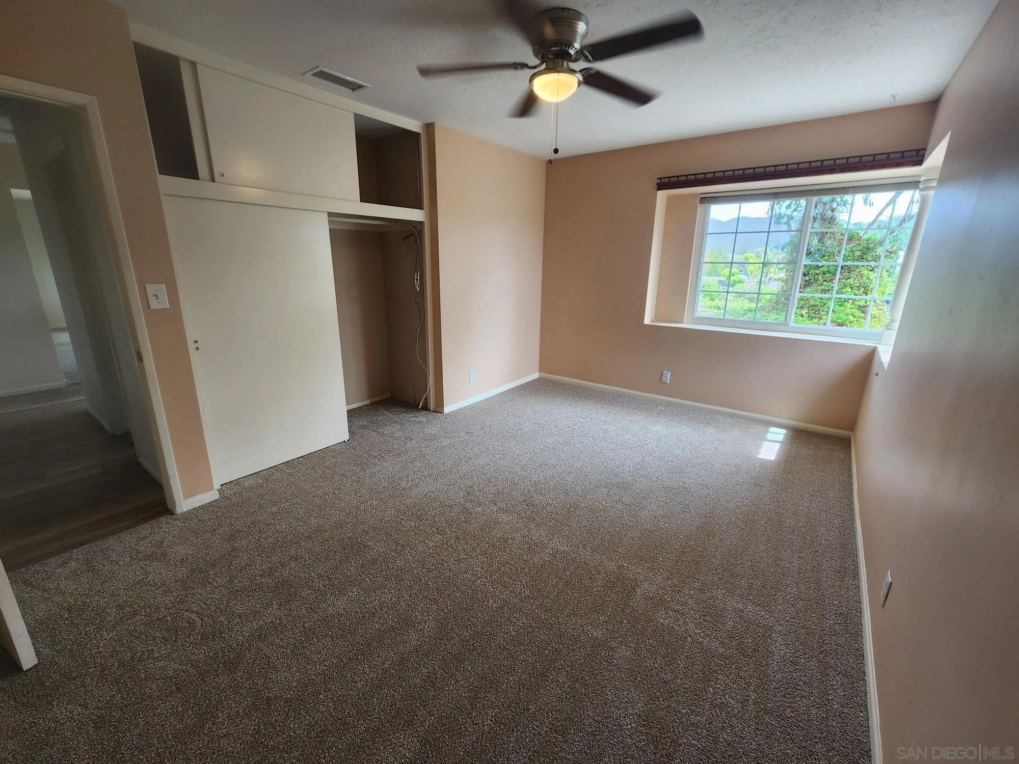 1972 Buena Creek Road Vista, CA 92084 - Photo 12 of 22 an empty room with windows and closet